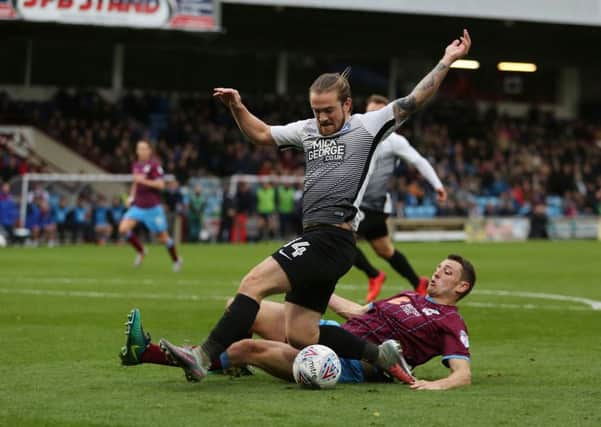 Posh striker Jack Marriott is tackled/fouled by Murray Wallace of Scunthorpe. Photo: Joe Dent/theposh.com.