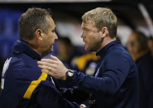 Rival managers Micky Mellon (left) and Grant McCann.