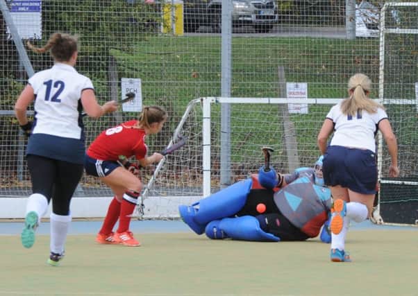 City of Peterborough Ladies skipper Robyn Gribble (red) in action against St Albans seconds.