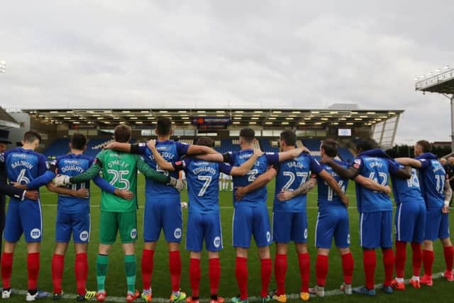 Posh players link arms for the Remembrance Day minute's silence before the Tranmere match. Photo: Joe Dent/theposh.com.