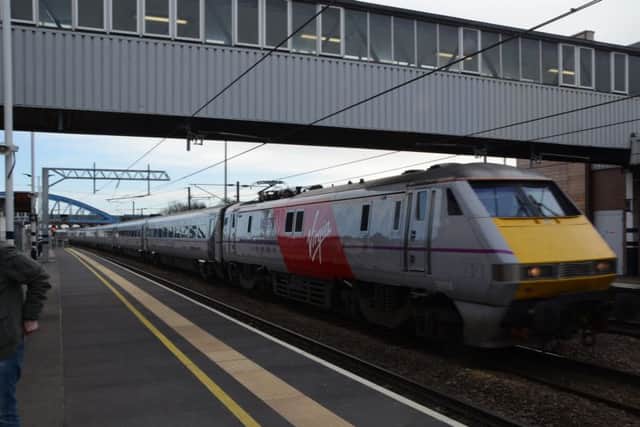 A Virgin train passing through Peterborough Station on a previous date EMN-150103-190007009