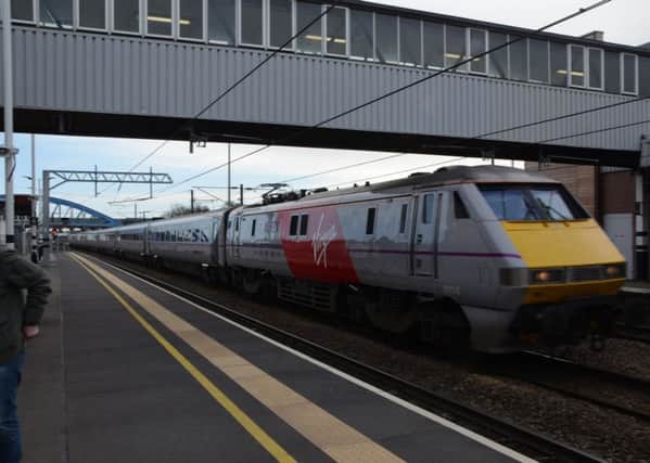 A Virgin train passing through Peterborough Station on a previous date EMN-150103-190007009