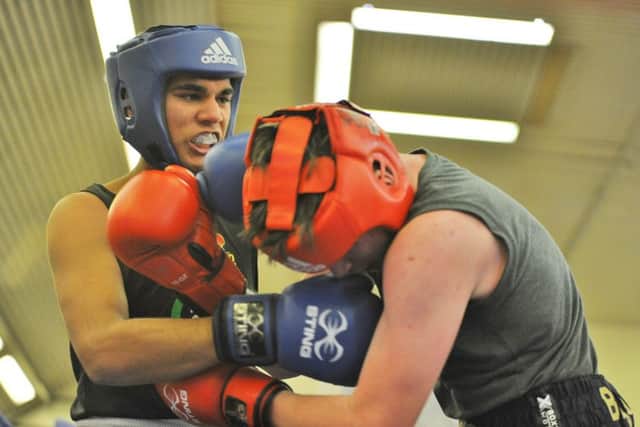 Amaan Nadeem gets stuck in against Keion Woulfe.