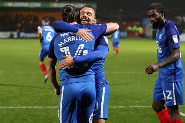 Jack Marriott is congratulated by Danny Lloyd after scoring for Posh at Cambridge. Photo: Joe Dent/theposh.com.