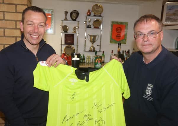 Peterborough Referees Association chairman Robert Windle (right) and  Premier League referee Kevin Friend with a signed shirt of Premier League referees which one lucky attendee at the Young Referees Night  will win.