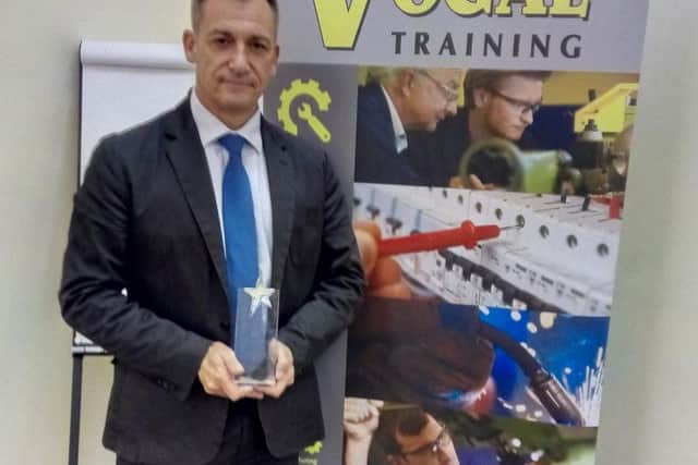 Rob Gault, managing director of Vogal Group, with the award for the firm's training course.