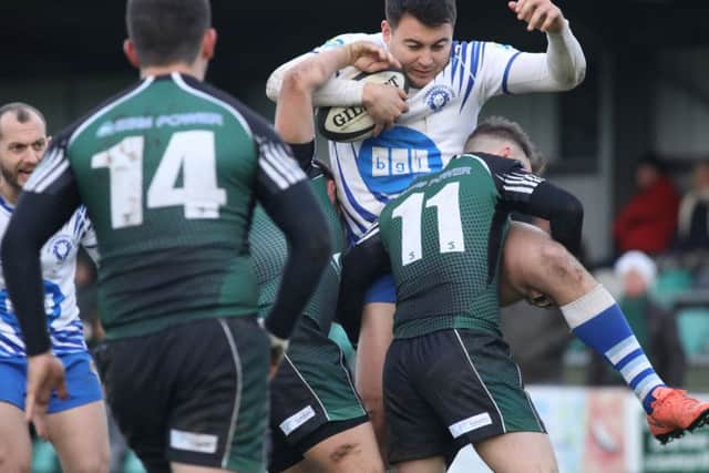 There's no way through for Lions winger Kaz Henderson against Scunthorpe. Picture: Mick Sutterby