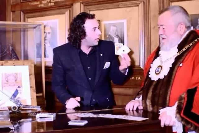 Sean Heydon wows Mayor cllr John Fox with his card tricks