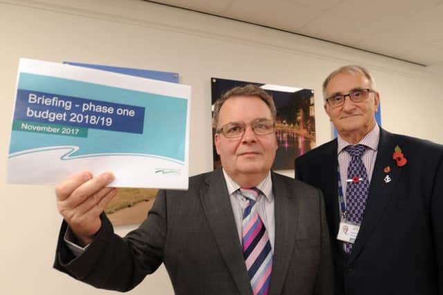 Coun David Seaton and Peterborough City Council Leader Coun. John Holdich with the 2018/9 budget EMN-171011-165633009