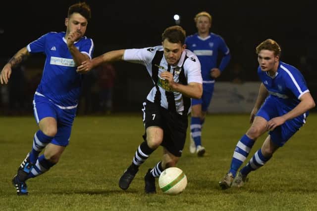 Lee Barsby (stripes) of Peterborough Northern Star in action against Boston Town. Photo: Chantelle McDonald. @cmcdphotos.