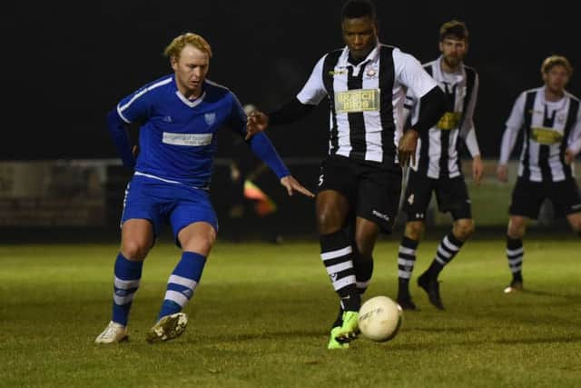 Wilkins Makate (stripes) of Peterborough Northern Star in action against Boston Town. Photo: Chantelle McDonald. @cmcdphotos.