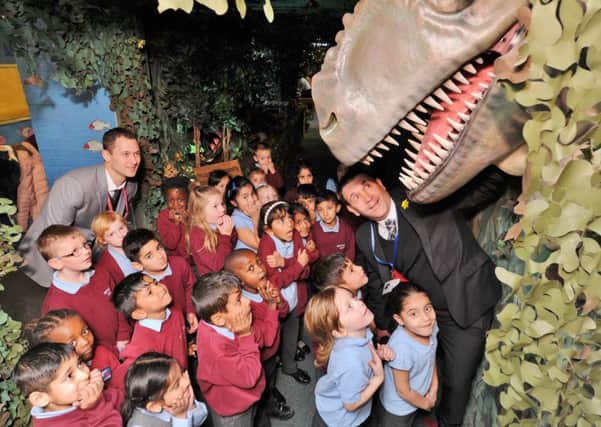 Principal Ben Erskine with sponsor Michael Simeoni from Nationwide School Uniforms and year 1 pupils looking at the new Dinosaurs corridor at the school. EMN-171114-131223009