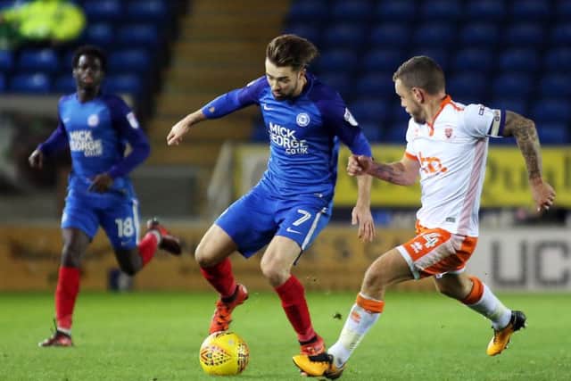 Posh substitute Gwion Edwards tries to get the better of Blackpool's Jay Spearing. Photo: Joe Dent/theposh.com.