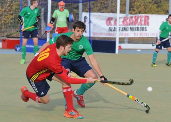 Four-goal Adam Wilson (red) in action for City of Peterborough against Chelmsford. Photo: David Lowndes.