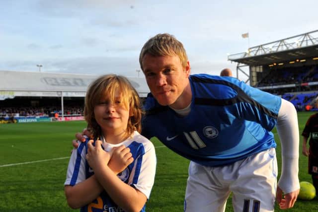 Posh manager Grant McCann with a previous Posh mascot in the days when he was first team captain.