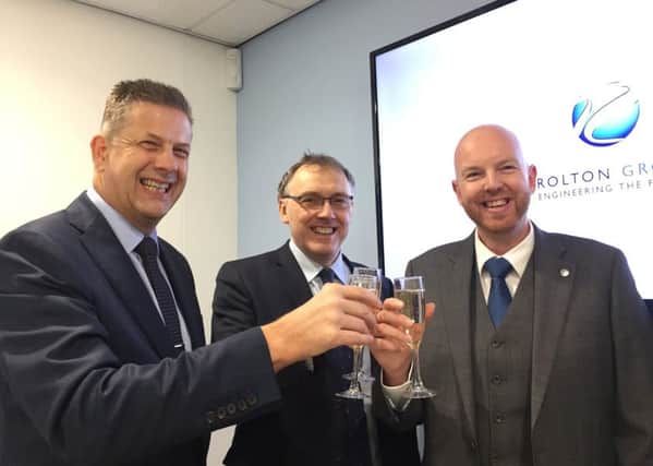 Cheers! Deputy managing director Chris Evans, chairman Peter Rolton and director Craig Smith.