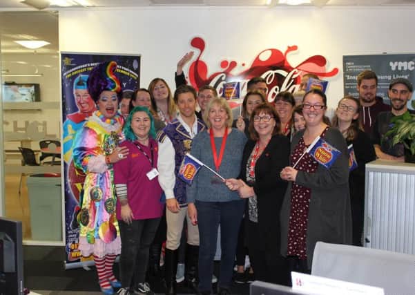 The cast of Snow White visits the offices of Coca-Cola European Partners in Woodston