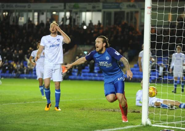 Jack Marriott wheels away in delight after putting Posh ahead against Portsmouth. Photo: David Lowndes.