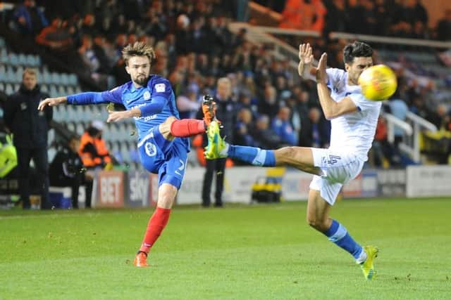 Gwion Edwards fires in a cross for Posh against Portsmouth. Photo: David Lowndes.
